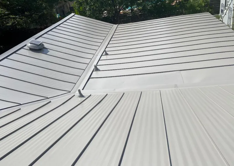 Solar attic fan installed on a metal roof for Roof Ventilation in Edgewater